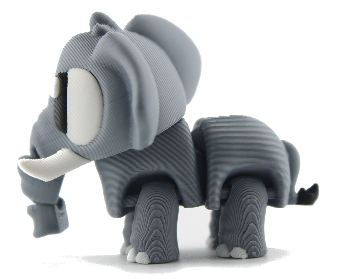 Side profile of the standing 3D printed elephant figurine facing left, gray with a long white tusk and white toenails