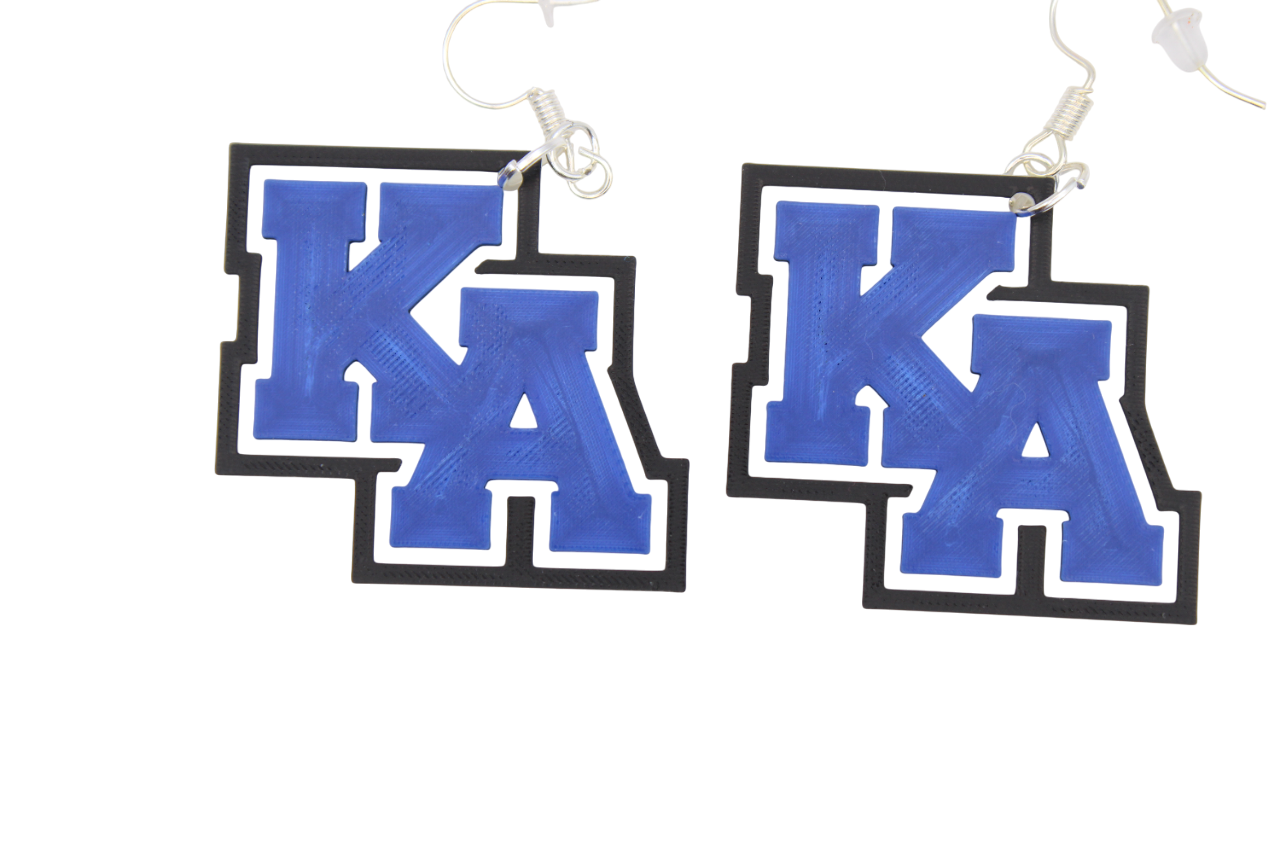 Pair of earrings with 'KA' design on a white background