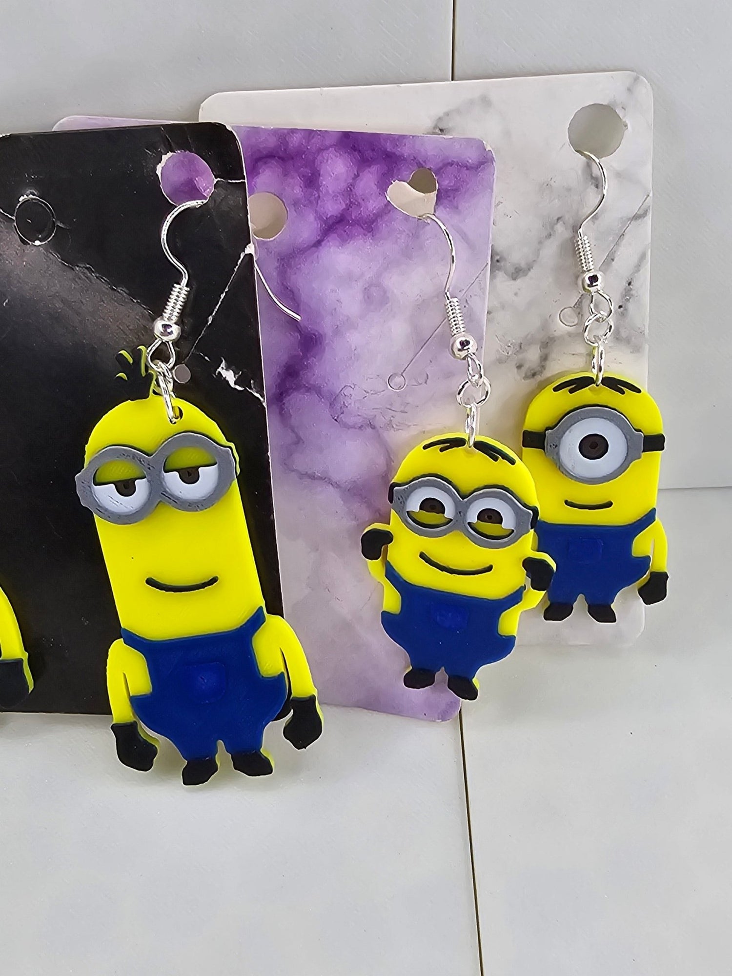 3D printed Minion earrings in yellow and blue featuring Kevin, Dave, and Stuart designs.