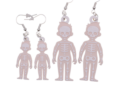 Four skeleton figure earrings in two sizes with cartoon bone details and metal hooks displayed side by side.